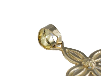 Close up of artist's hallmark stamp on gold pendant