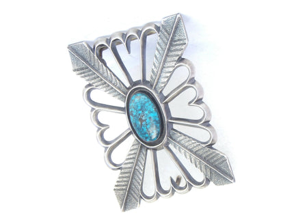 Front angled silver tufa cast buckle with a turquoise stone 