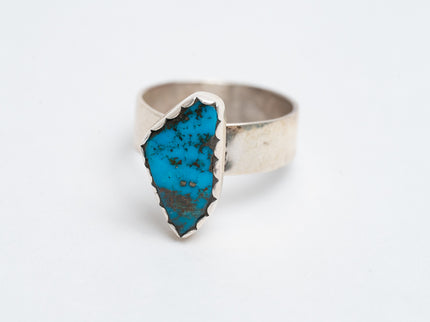 Authentic silver ring with a Kingman turquoise gemstone on a white background