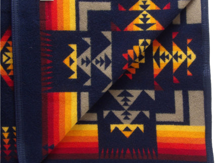 Pendleton Chief Joseph Blanket in Indigo, featuring a traditional Native American-inspired geometric pattern with arrow motifs, folded neatly to show intricate design and soft wool texture. Inside View 