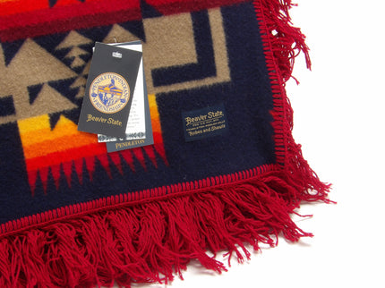 Pendleton Chief Joseph Shawl in indigo, featuring a traditional Native American-inspired geometric pattern with arrow motifs, folded neatly to show intricate design and soft wool texture. Front tag view 