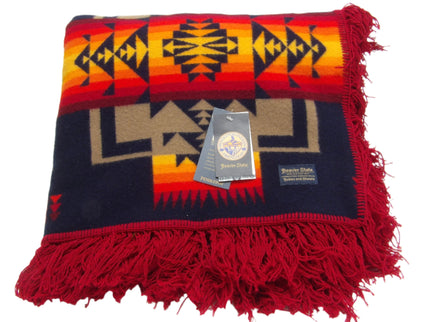 Pendleton Chief Joseph Blanket in indigo, featuring a traditional Native American-inspired geometric pattern with arrow motifs, folded neatly to show intricate design and soft wool texture. Front View 
