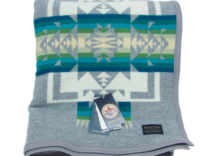 Pendleton Chief Joseph Blanket in Grey featuring a traditional Native American-inspired geometric pattern with arrow motifs, folded neatly to show intricate design and soft wool texture. front View 