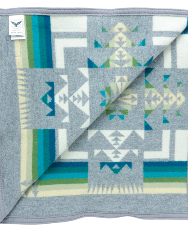 Pendleton Chief Joseph Blanket in grey featuring a traditional Native American-inspired geometric pattern with arrow motifs, folded neatly to show intricate design and soft wool texture, inside view