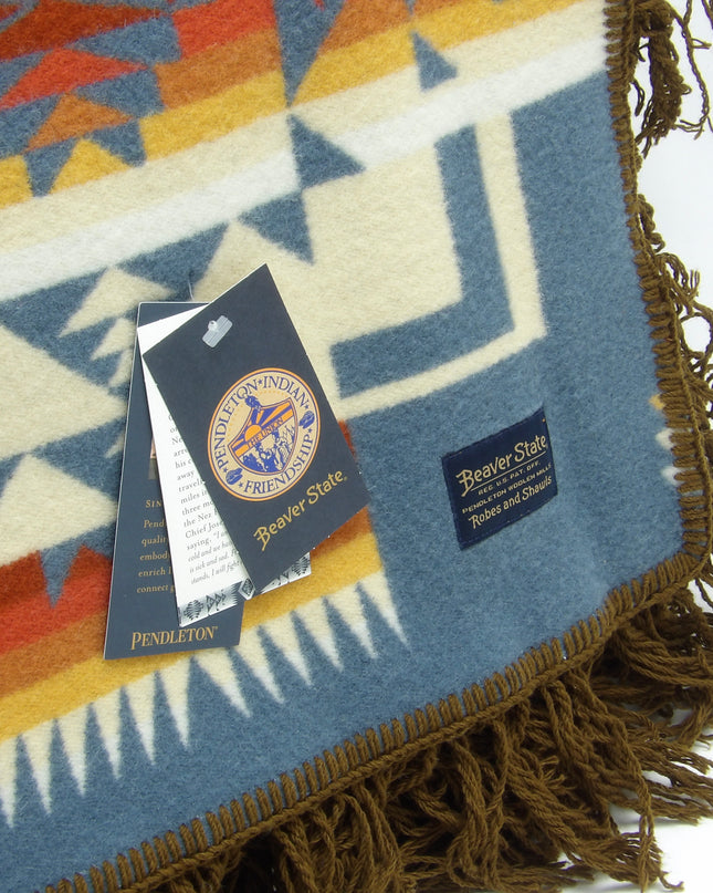 Pendleton Chief Joseph Blanket in Shale featuring a traditional Native American-inspired geometric pattern with arrow motifs, folded neatly to show intricate design and soft wool texture, Tag view