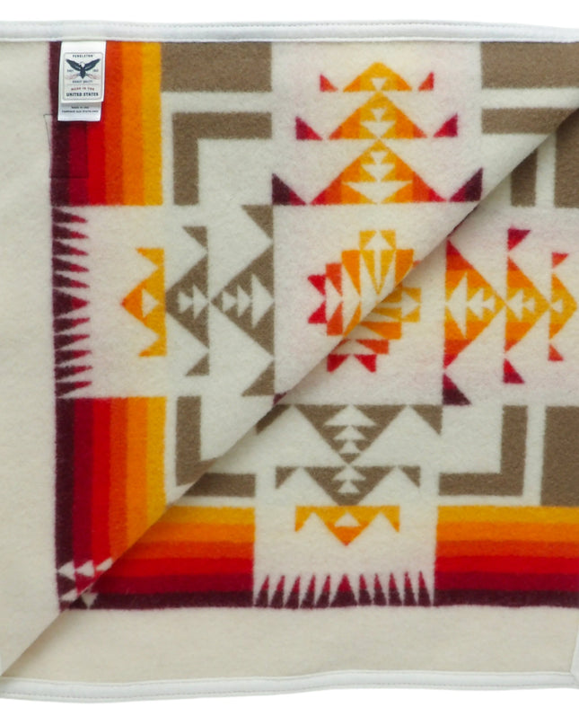 Pendleton Chief Joseph Blanket in Ivory featuring a traditional Native American-inspired geometric pattern with arrow motifs, folded neatly to show intricate design and soft wool texture, inside view
