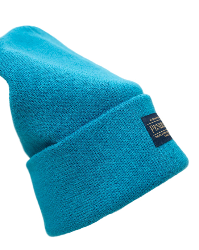 Pendleton teal knitted beanie with a tag on brim back on a white background