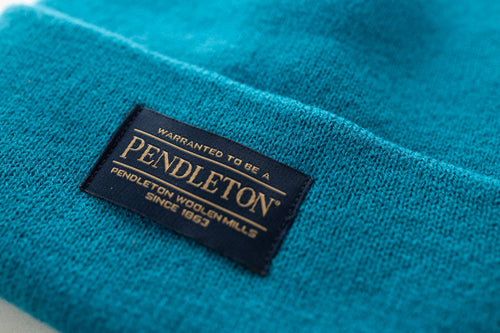 Close-up of Pendleton tag on teal beanie