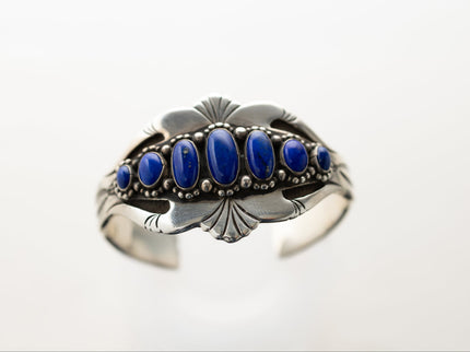 Silver stamped bracelet with lapis stones on a white background