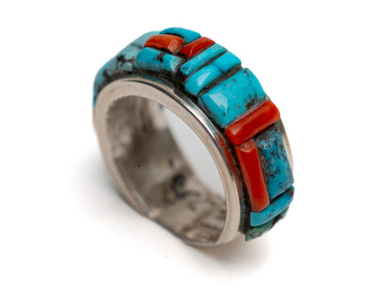 Ring with turquoise and coral stone inlay on a white background