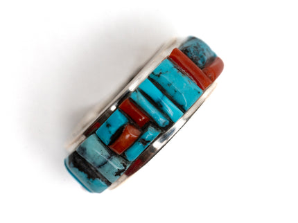 Silver ring with turquoise and coral stone inlay on a white background