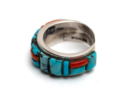 Sterling silver ring with turquoise and coral stone inlay on a white background
