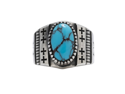 Navajo designed silver ring with one Egyptian turquoise stone and 8 crosses etched on top displayed on a light gray background