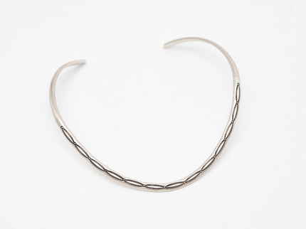 Silver thin Native American contemporary chocker necklace on a white background