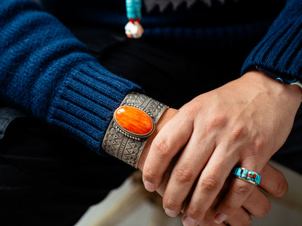 Close-up of male hands wearing a Native American bracelet and ring
