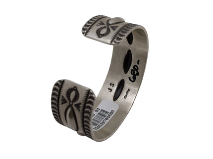 Artisan sterling silver cuff bracelet with raised repousse ovals and hand-stamped geometric detailing in a heritage Southwestern style.
