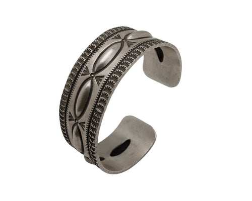 Artisan sterling silver cuff bracelet with raised repousse ovals and hand-stamped geometric detailing in a heritage Southwestern style.