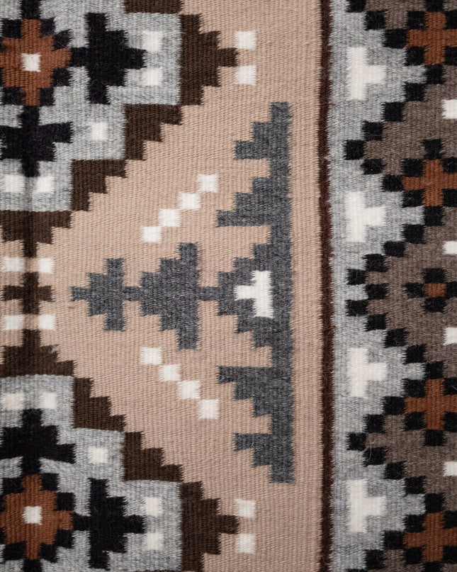 Hand-woven Navajo Rug with geometric pattern on a plain white background, side center view