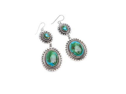 Turquoise stone earrings with silver settings on a white background
