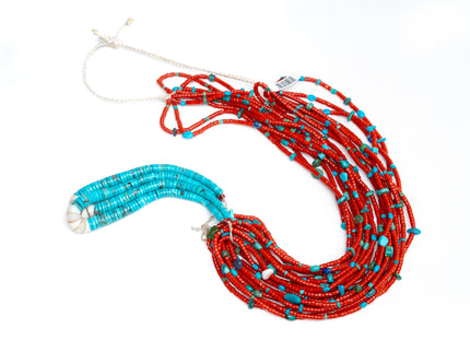 Single Native American necklace with nine strands of Mediterranean coral with sleeping beauty, Royston and Kingman Turquoise stones, and Lapis on a white background