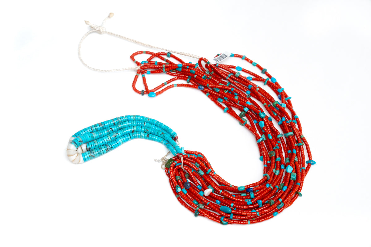 Single Native American necklace with nine strands of Mediterranean coral with sleeping beauty, Royston and Kingman Turquoise stones, and Lapis on a white background