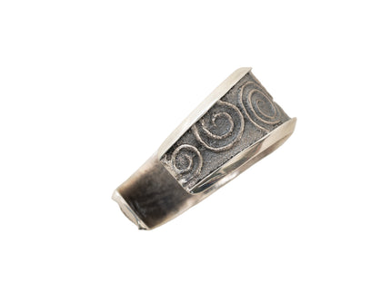 Side view of a silver cuff bracelet with spiral pattern on a white background