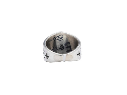 Back and inside view of a Navajo silver ring with engraved designs on a white background