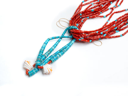 Coral and turquoise beaded necklaces on a white background