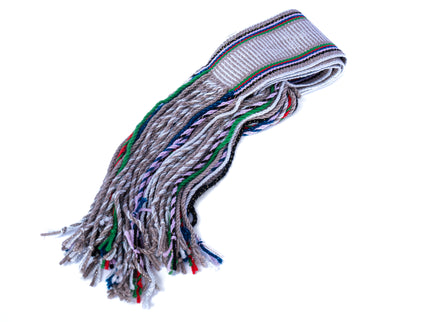 A hand woven Navajo gray and silver sash belt with fringed ends.