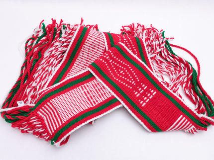 Red and white traditional sash with two green lines laid out on a white background