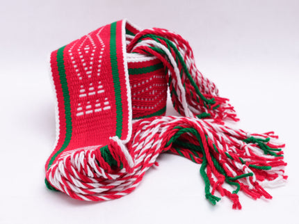 Red and white traditional sash with two green lines rolled up on a white background