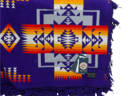 Pendleton Chief Joseph Blanket in purple featuring a traditional Native American-inspired geometric pattern with arrow motifs, folded neatly to show intricate design and soft wool texture front view