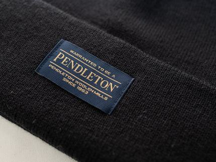 Close up of the Pendleton tag on a black classic beanie