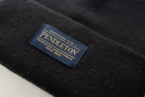 Close up of the Pendleton tag on a black classic beanie
