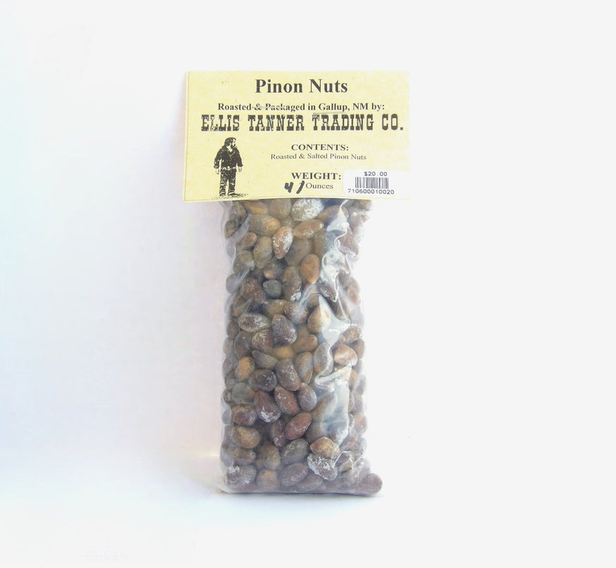 A clear plastic package containing 4 ounces of roasted piñon nuts, with a label displaying the brand name, product name, and weight.