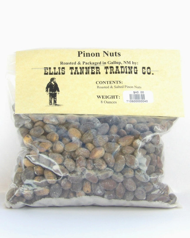 A clear plastic package containing 8 ounces of roasted piñon nuts, with a label displaying the brand name, product name, and weight.