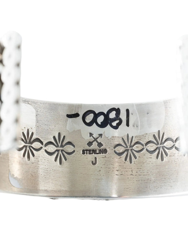 Silver bracelet with coral and white beads on a white background