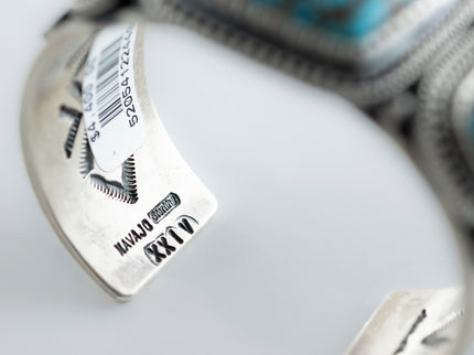Inside view of year mark and "sterling" mark with a small stamp "Navajo", placed on a white background 