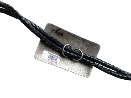 Black leather cord being looped through two silver circular loops on the back of a rectangular bolo tie