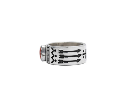 Profile view a Navajo silver ring with one coral stone and 3 black arrows stamped on the band