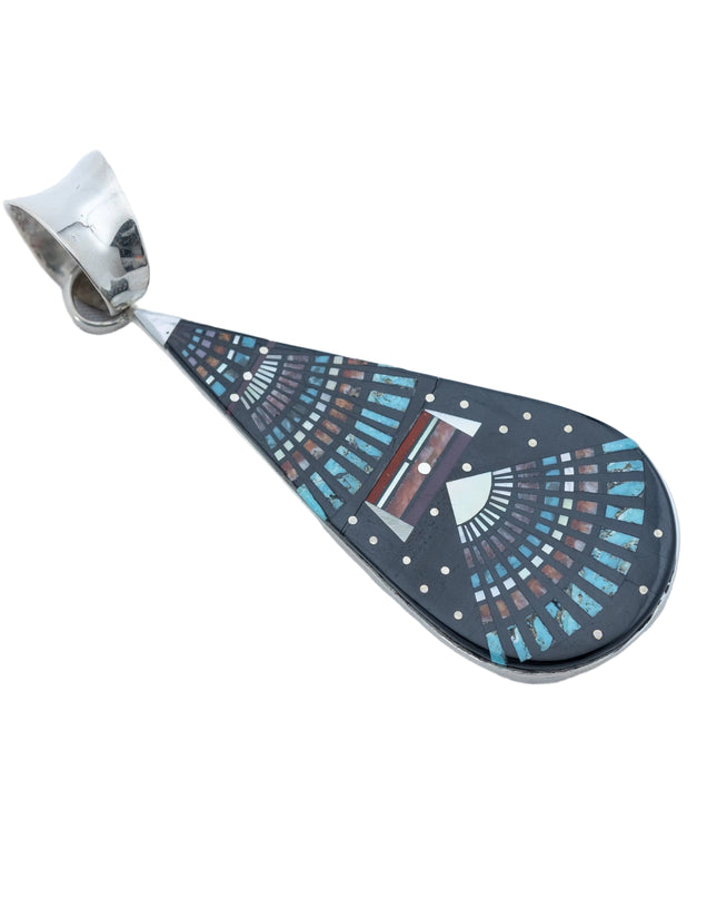 Teardrop-shaped pendant with decorative night Sky pattern, placed in a silver plate and silver bail at the top, on a white background