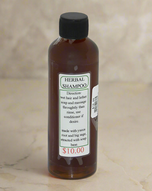 Small clear bottle filled with Navajo herbal shampoo with a simple label