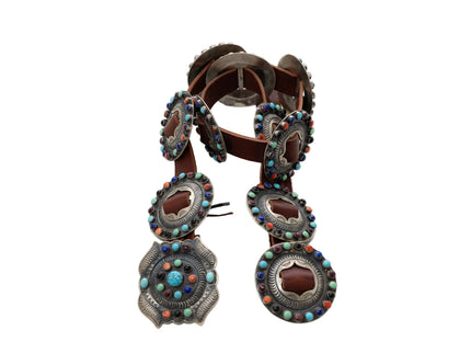 Decorative leather belt with colorful stone embellishments on a white background