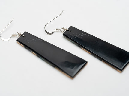 Black rectangular Zuni earrings on a white background
