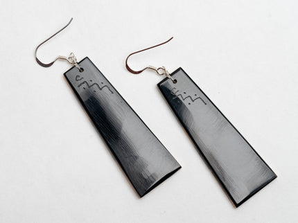 Pair of Zuni inlay native American rectangular earrings on a white background