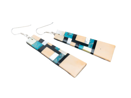 Pair of Zuni earrings with geometric inlay design on a white background