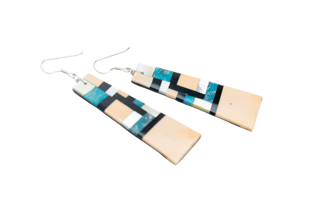 Pair of Zuni earrings with geometric inlay design on a white background