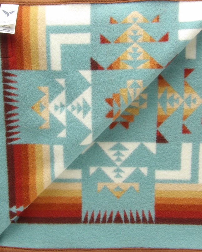 Pendleton Chief Joseph Blanket in aqua, featuring a traditional Native American-inspired geometric pattern with arrow motifs, folded neatly to show intricate design and soft wool texture