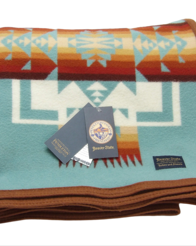 Pendleton Chief Joseph Blanket in aqua, featuring a traditional Native American-inspired geometric pattern with arrow motifs, folded neatly to show intricate design and soft wool texture. front View 