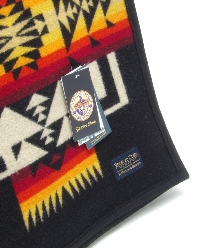 Pendleton Chief Joseph Blanket in Black, featuring a traditional Native American-inspired geometric pattern with arrow motifs, folded neatly to show intricate design and soft wool texture. tag view
